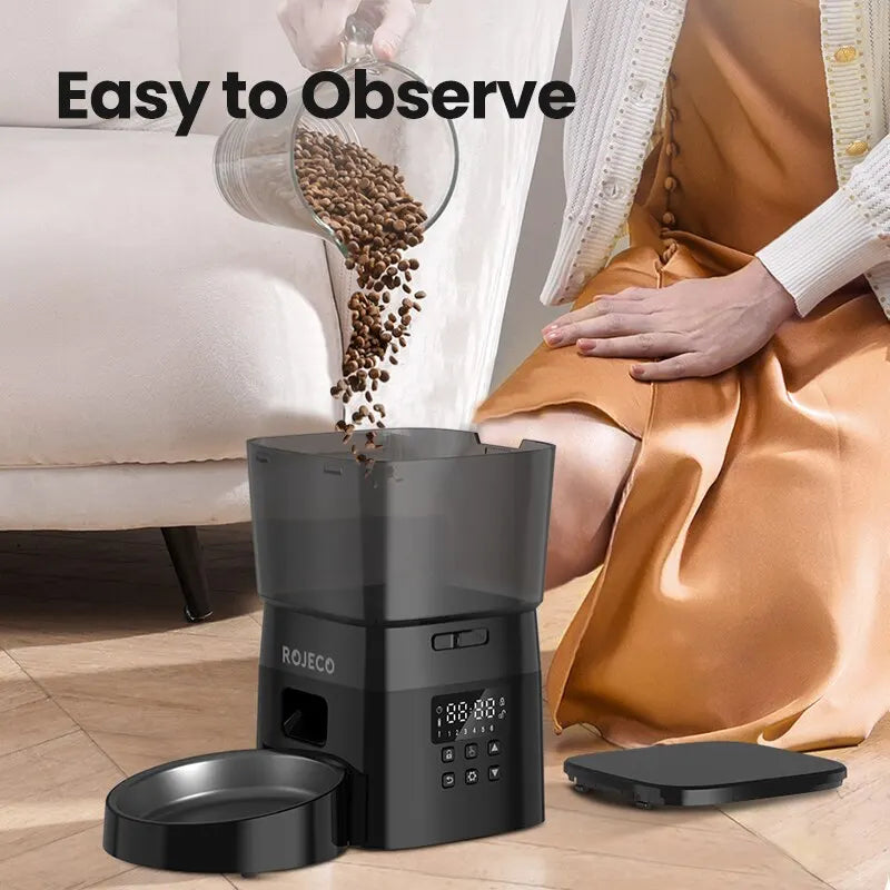 Roieco coffee grinder with coffee beans being poured into it, on a wooden floor.