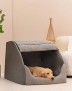 Small dog inside warm gray pet bed showing cozy interior
